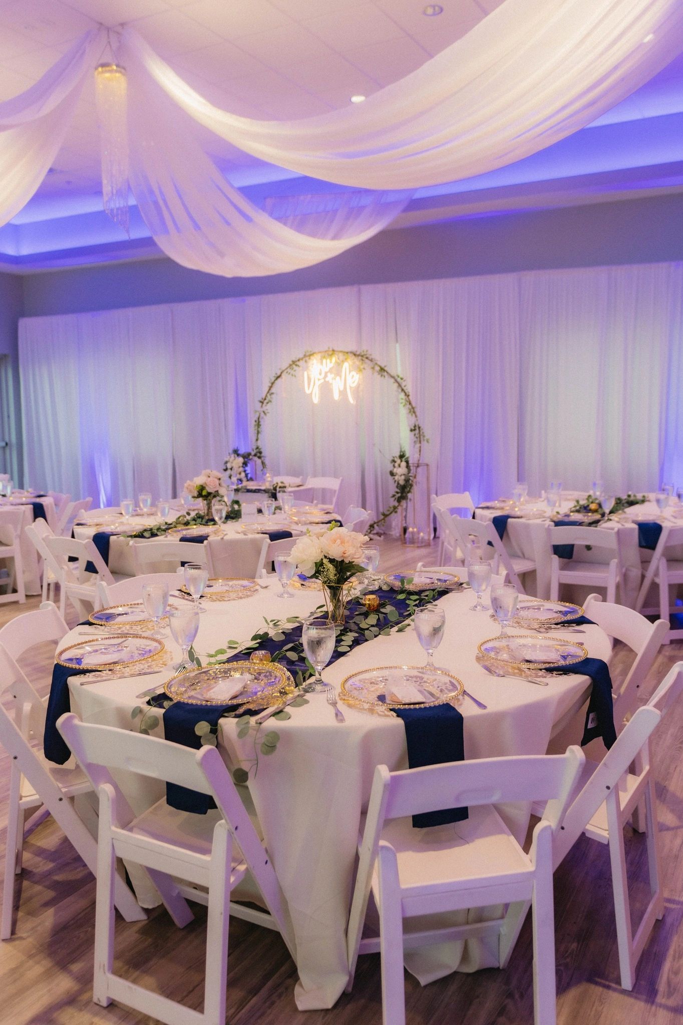 Team House Tampa wedding reception ballroom with purple lighting and floral arch